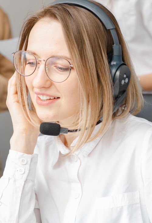 Free Customer support agent providing service with a smile, using headset. Stock Photo