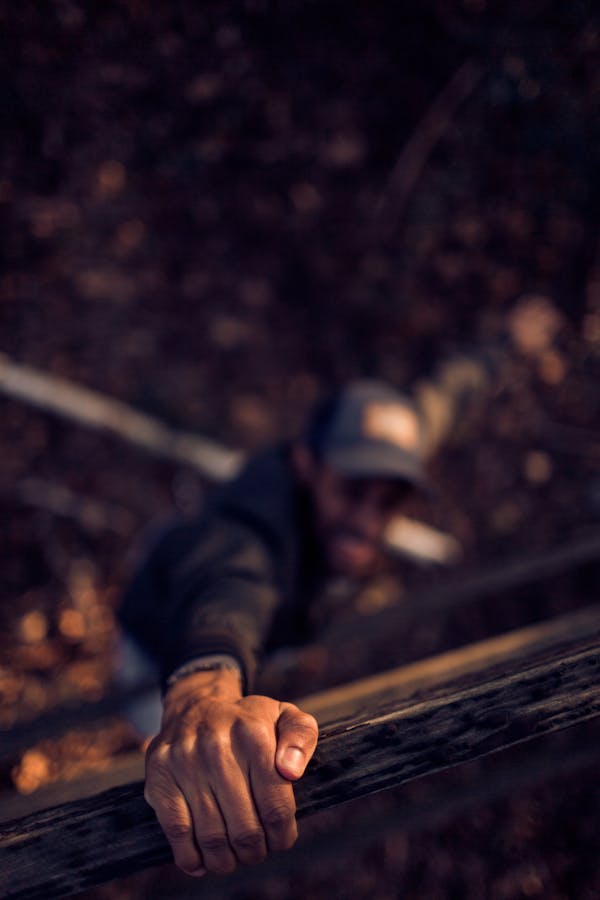 Man Holding On Wood
