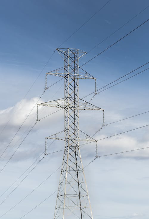 Free Photo of a Transmission Tower Under a Blue Sky Stock Photo