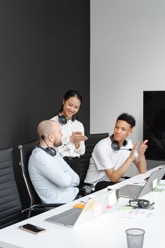Team members in headsets working together in a bright office space, fostering collaboration and communication.