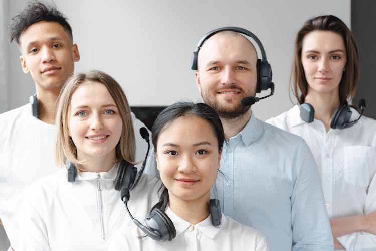 Smiling Call Center Agents Looking At Camera