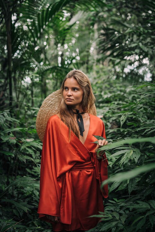 Woman in a Silk Dress Posing in the Middle of a Rainforest