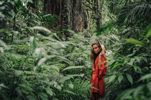 Woman in Robe Standing in the Forest