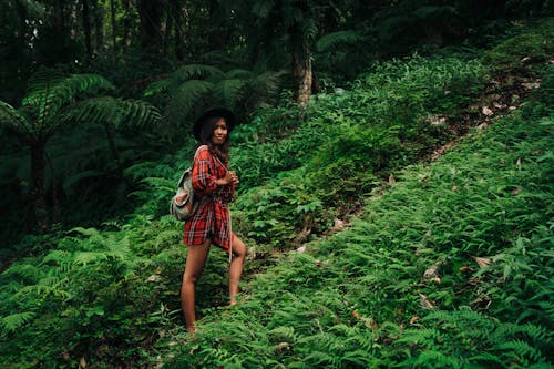 Woman in Plaid Shirt  Walking on the Pathway