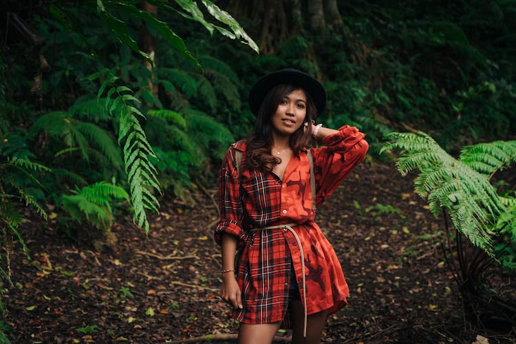 Woman In Red Button Down Shirt Standing On A Pathway