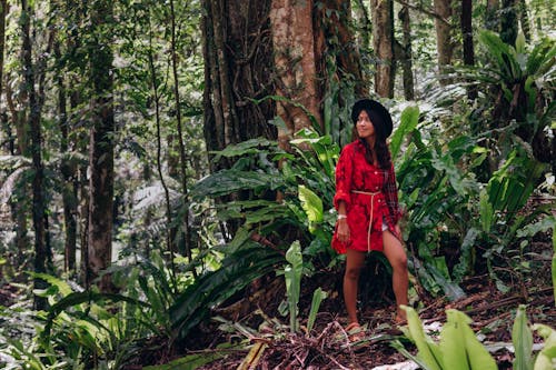 Free Woman in Red Polo Standing in the Middle of the Forest Stock Photo