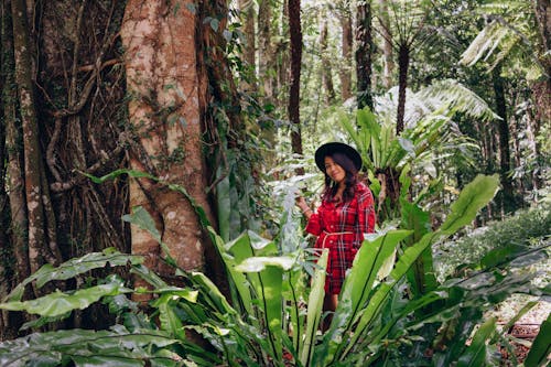 Woman in Red Long Sleeves Holding Wild Plants