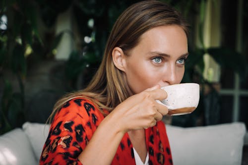 Woman in Red Dress Drinking Coffee