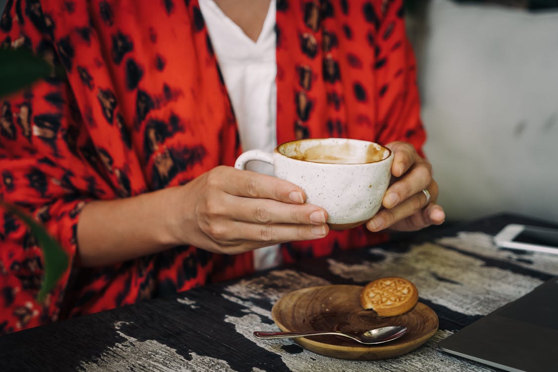 Person Holding a Ceramic Cup