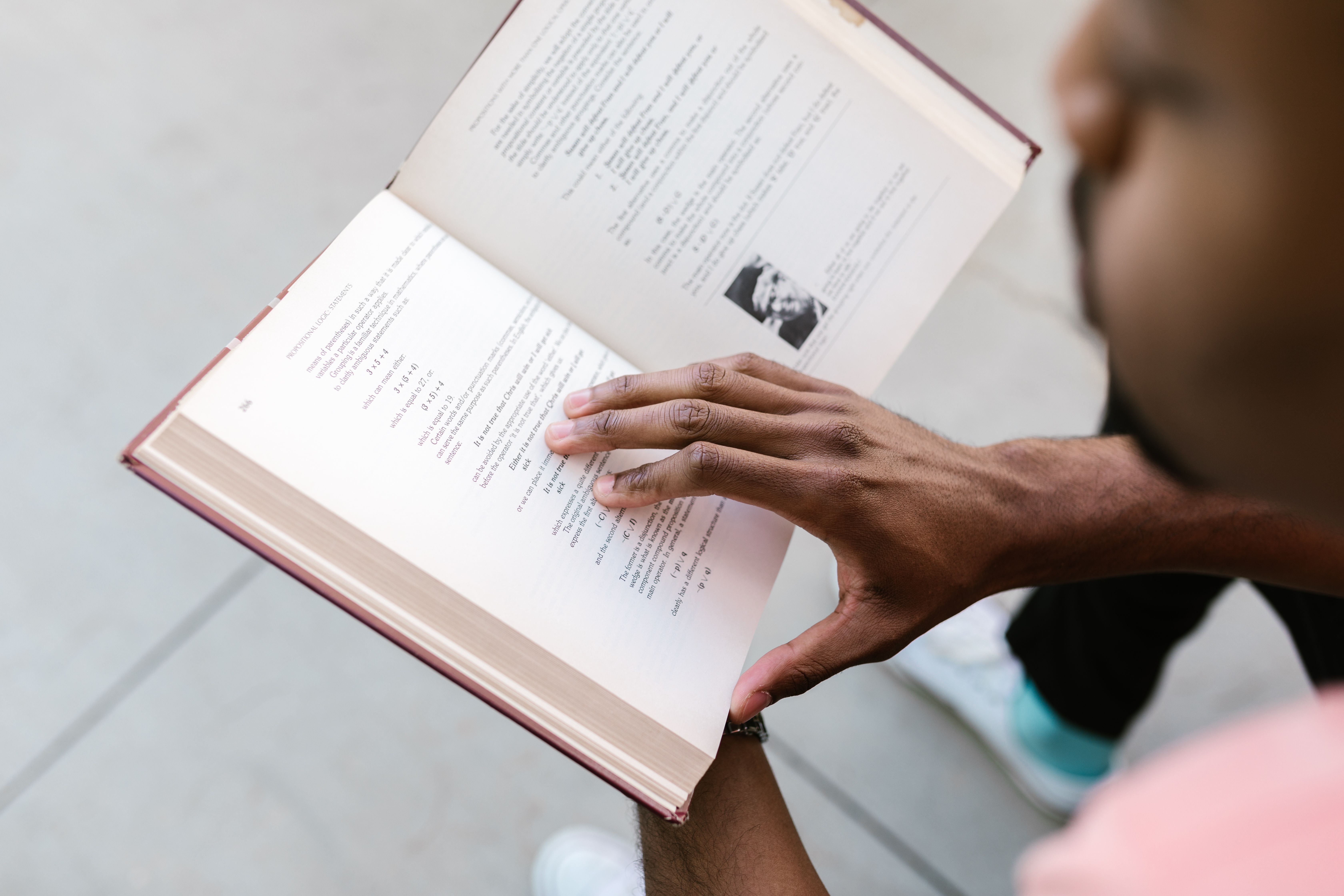 Reading Seriously A Man Reading a Book ยท Free Stock Photo