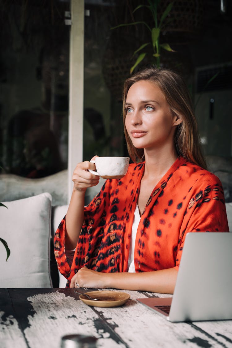 Woman Wearing A Robe Drinking A Cup Of Coffee