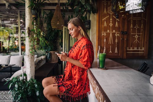 Woman Sitting Beside a Bar Counter