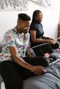Man Playing Card Game with a Woman Sitting on the Bed