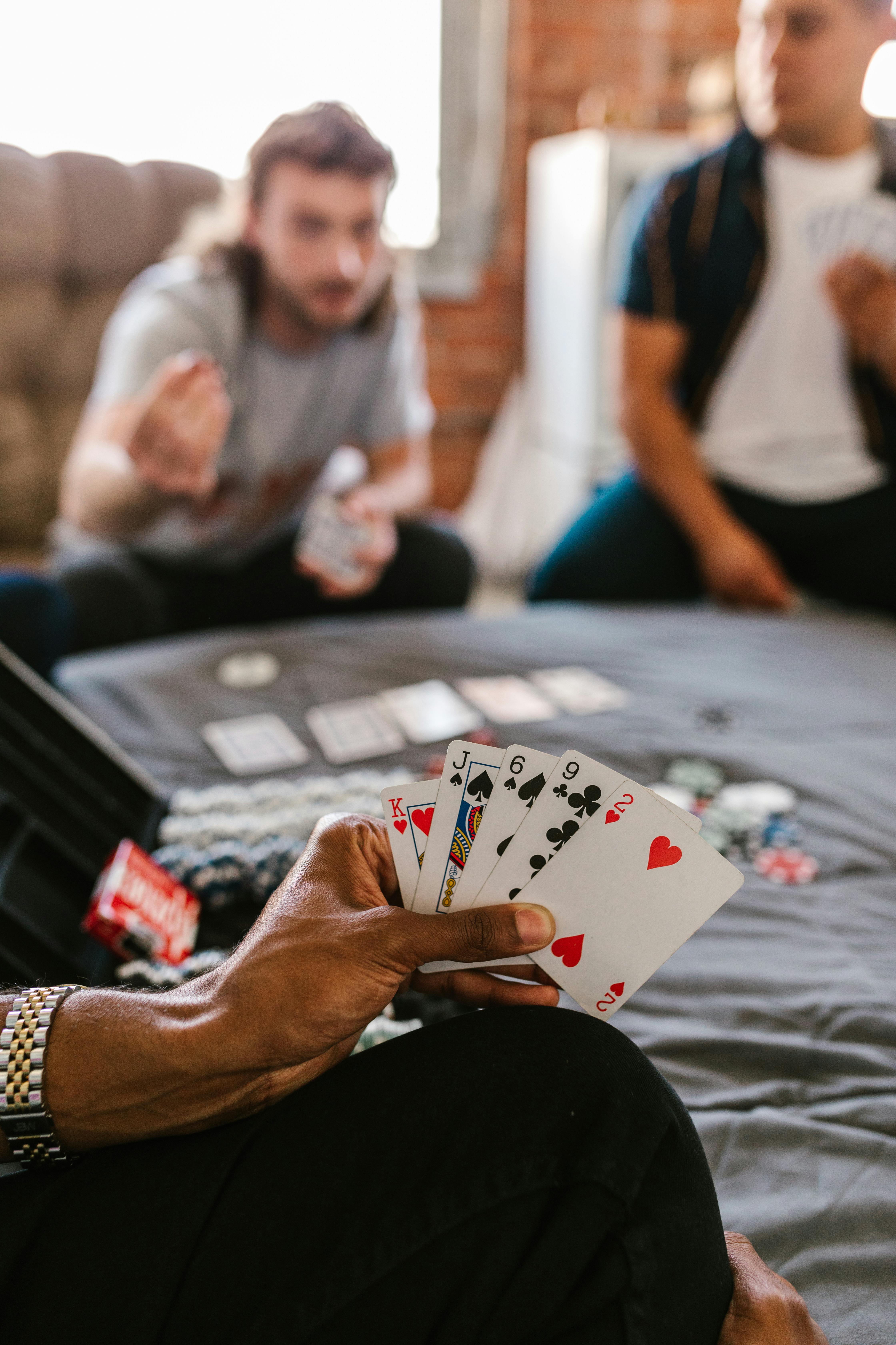 person holding playing cards