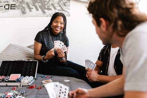 A Woman in Black Shirt Holding Playing Cards