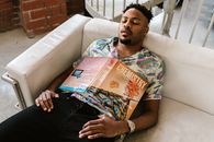 Woman in White Green and Pink Floral Shirt Reading Magazine
