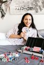 Woman in White and Red Polka Dot Shirt Holding Black Tablet Computer