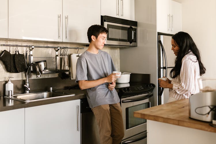 Man And Woman Talking At A Kitchen