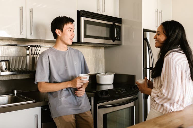 Friends Having Coffee At The Kitchen