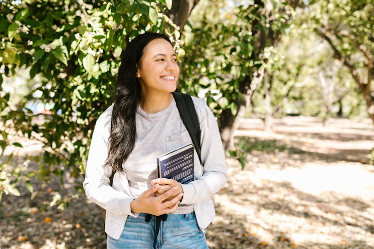 Smiling Woman Holding Her Book