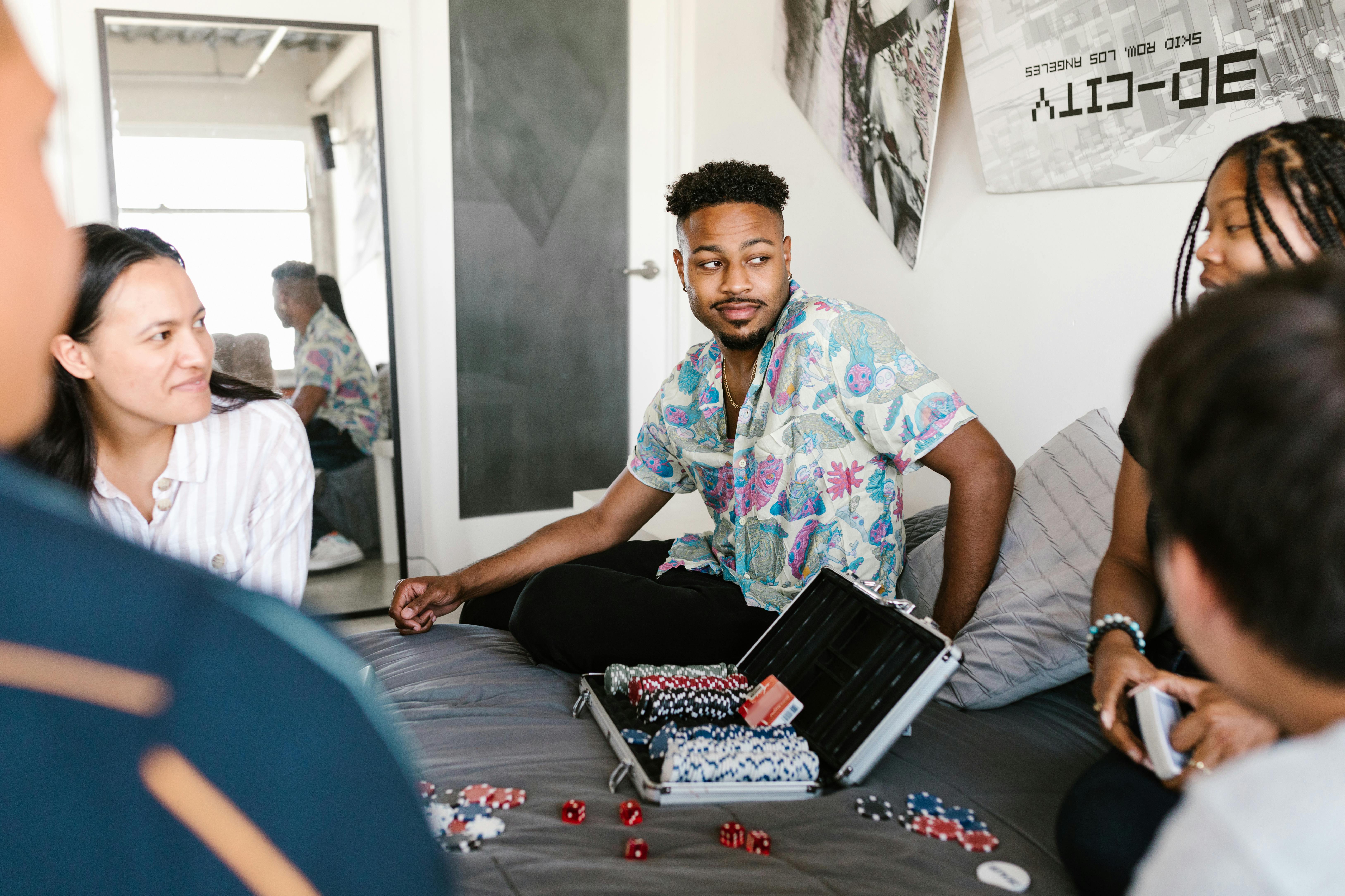 A group of friends playing poker in a cozy room, showcasing diversity and enjoyment.