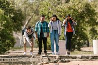 College Students Standing Near the Body of Water