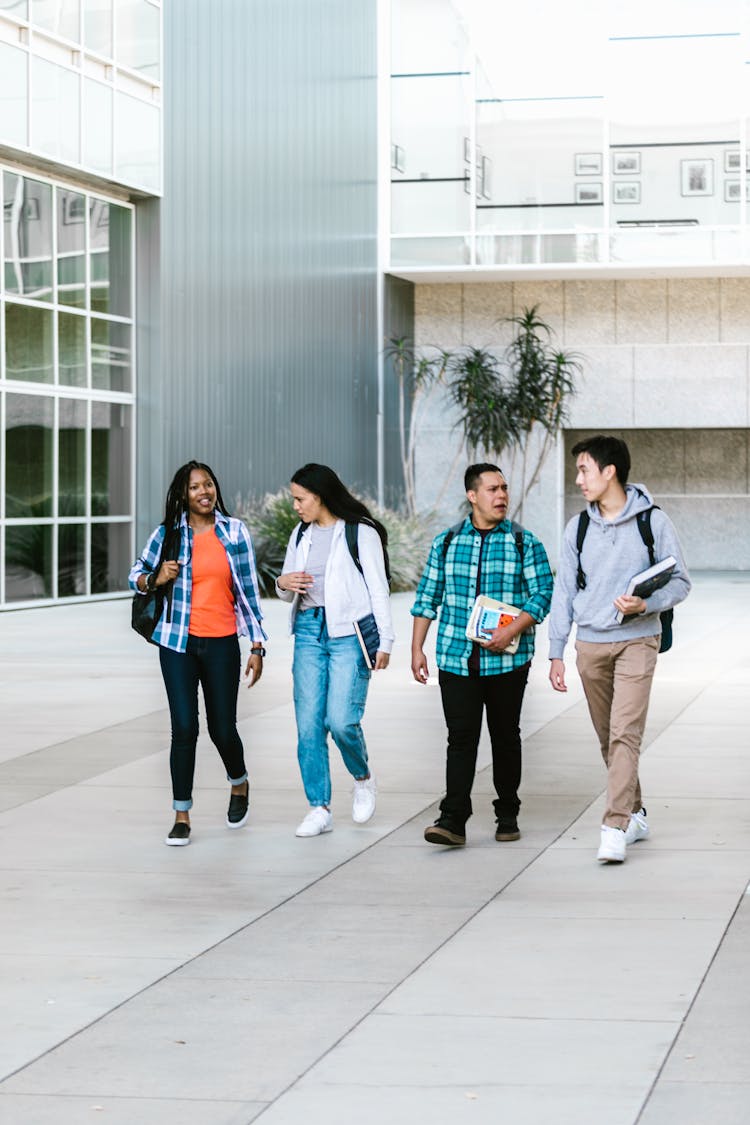 A Group Of College Students Walking At The Campus 