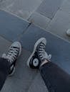 A Person Wearing a Black and White Converse