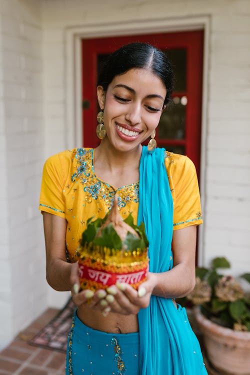 Free Smiling Woman Holding a Kalash Stock Photo