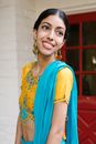 Woman in Blue and Yellow Floral Dress Smiling