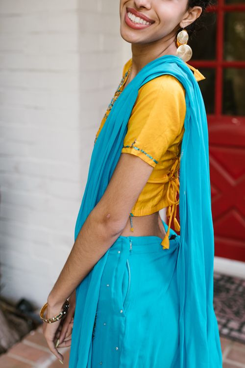 Smiling Woman Wearing a Traditional Dress Posing · Free Stock Photo