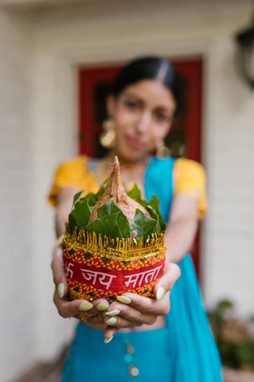 Person Holding a Diwali Kalash