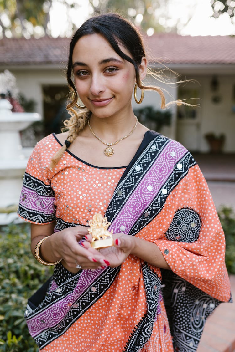 Beautiful Woman Holding A Figurine