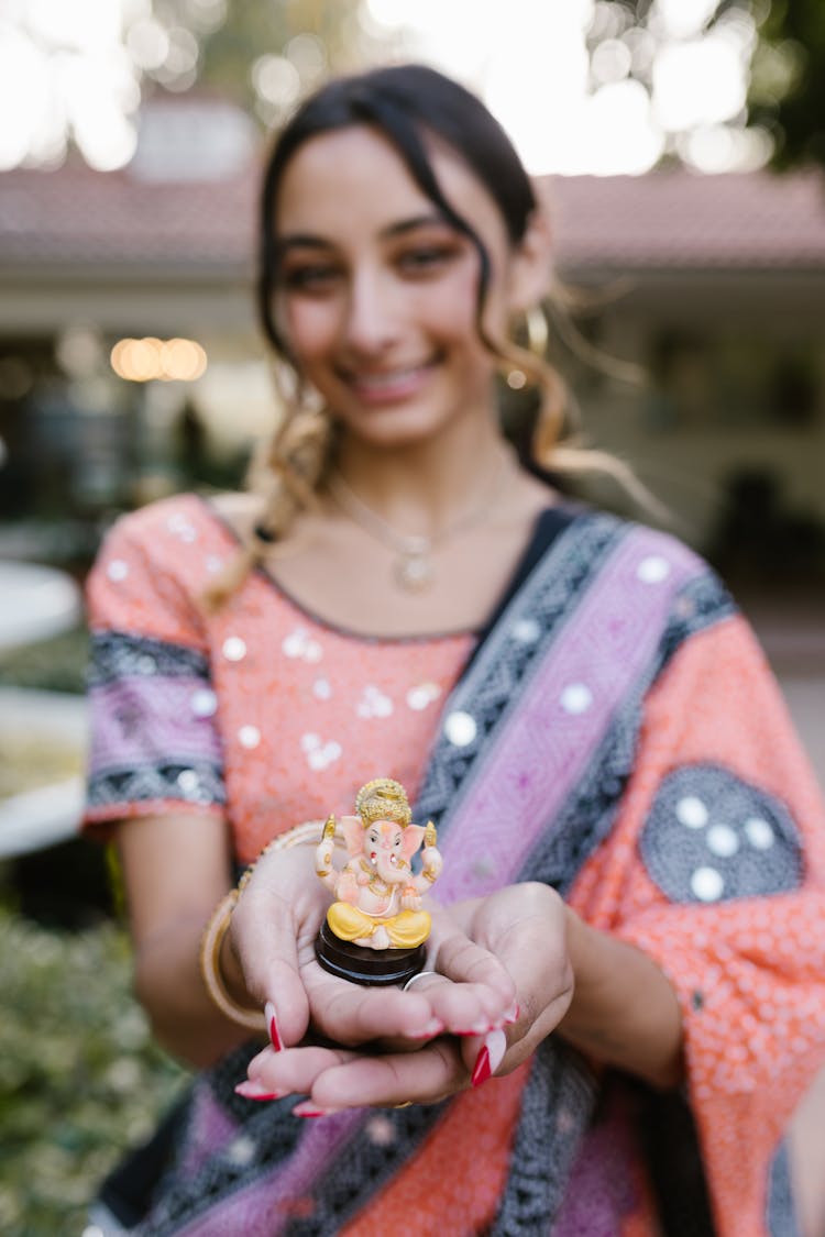 Woman Holding An Elephant Figurine