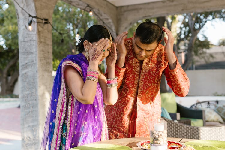 Man And Woman Holding Their Heads