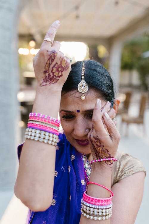 Free A Woman with Bangles and Mehndi on Her Arms Stock Photo
