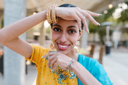 Vibrant outdoor portrait of a smiling woman in traditional attire, highlighting her jewelry and cheerful expression.