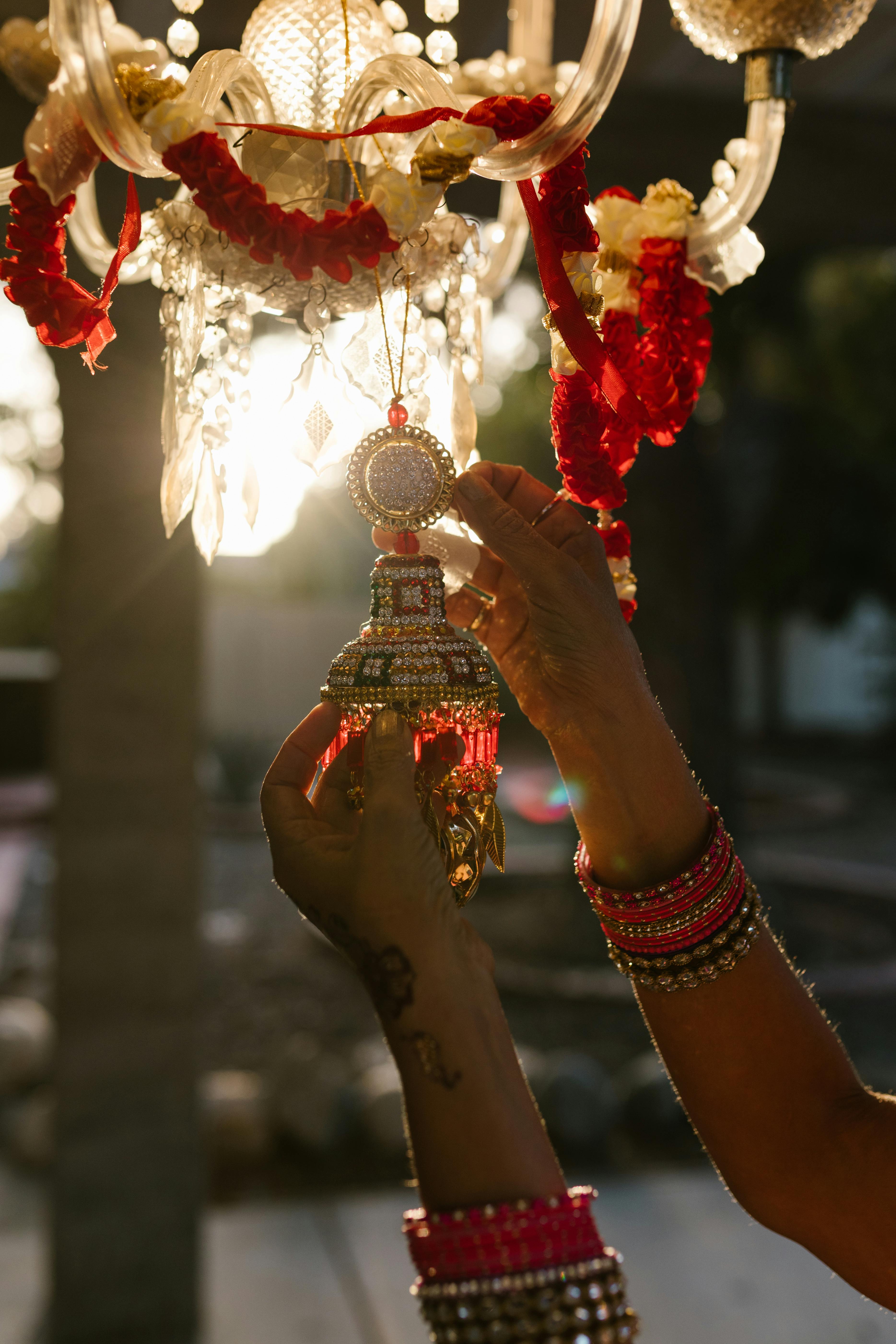 woman hanging a bell in sunlight