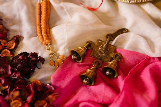 Colorful arrangement of Ganesha bells, beads, and petals symbolizing Indian festivals and traditions.