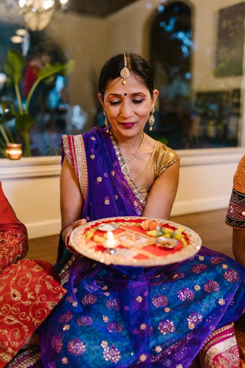 Woman in Traditional Clothing Holding Puja Thali