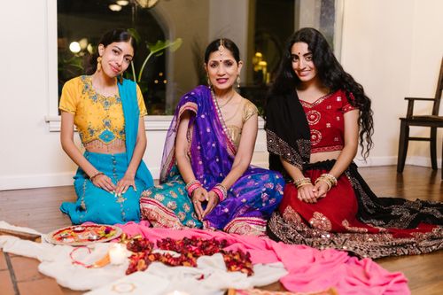 Free A group of women in colorful saris participating in an indoor cultural celebration. Stock Photo