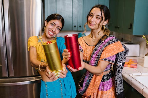 
Women Wearing Saree Holding Gifts