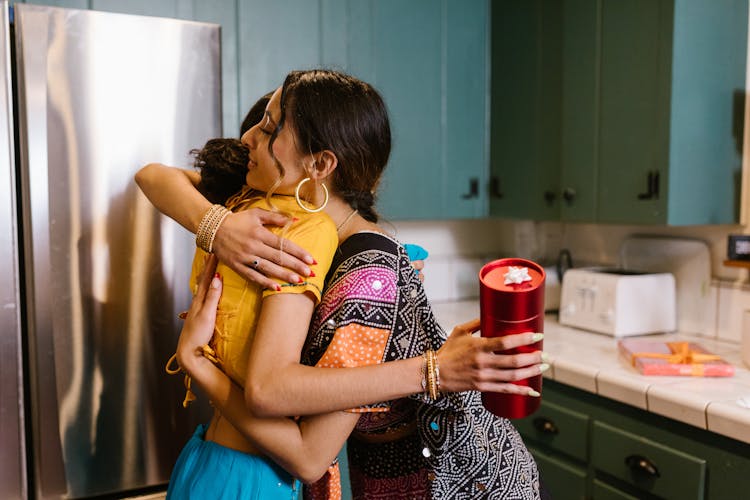 Women At The Kitchen Hugging Each Other 