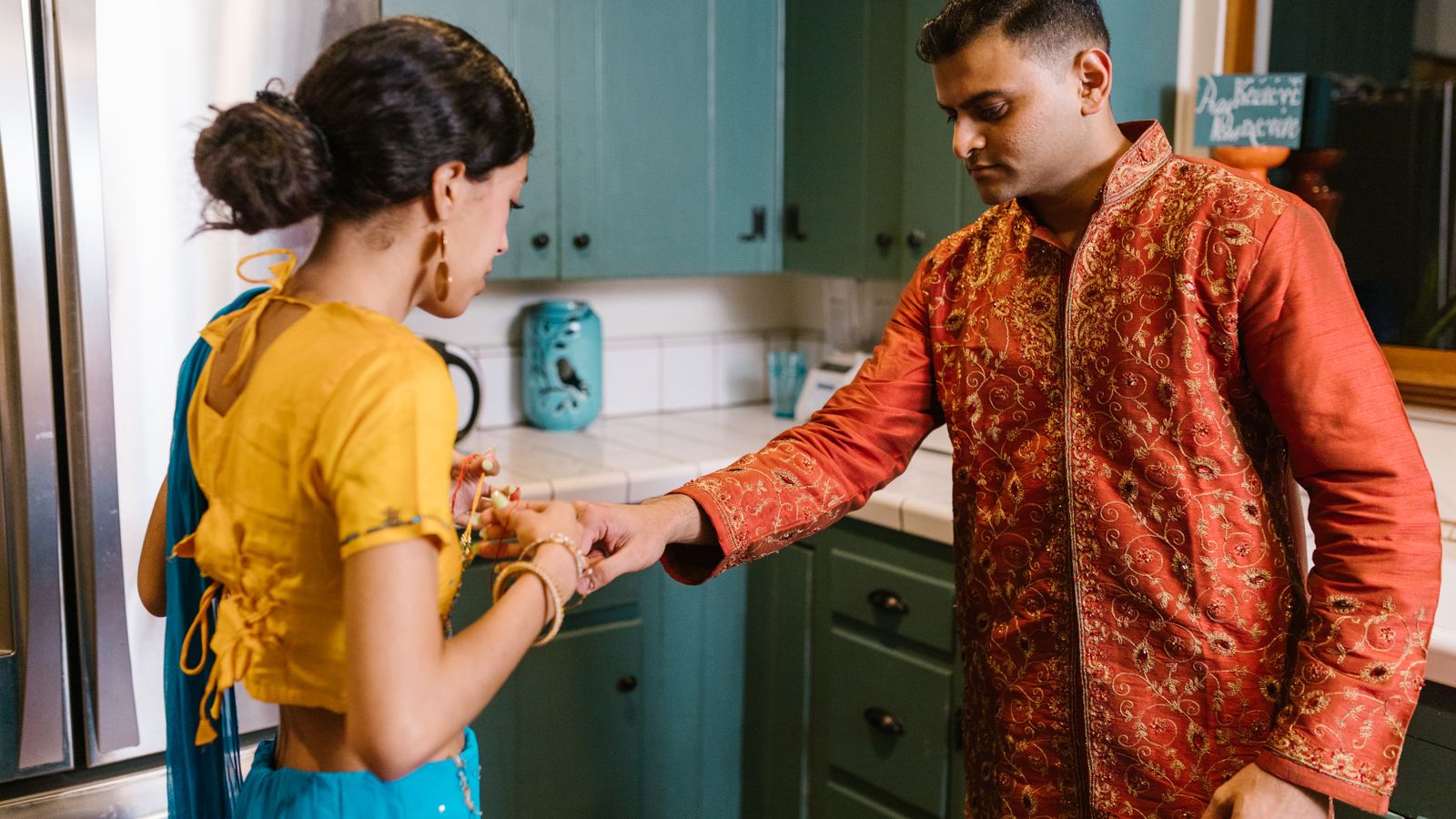 A couple in traditional Indian attire at home