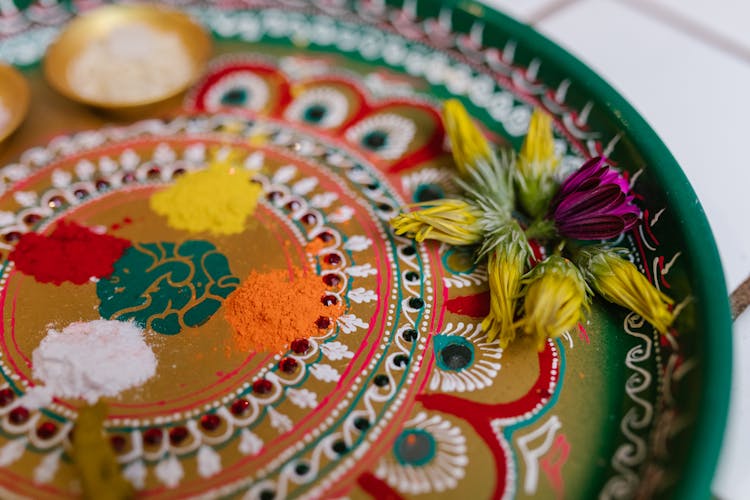 A Puja Thali With Powders And Flowers