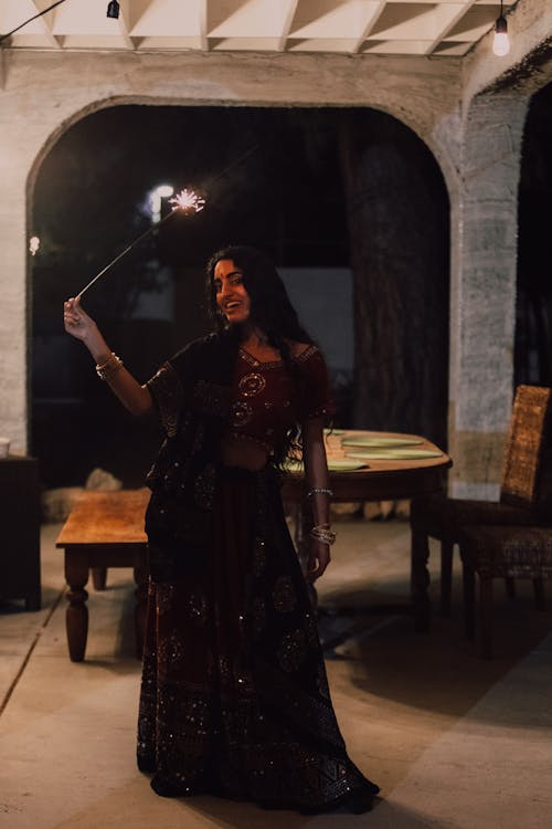 Alluring Woman in Traditional Wear holding a Sparkler