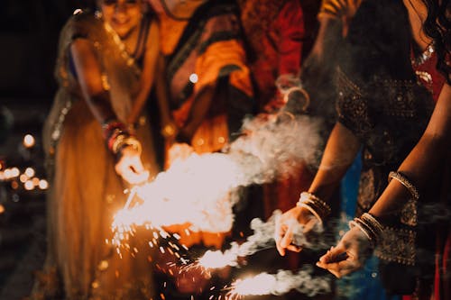 People Holding Sparklers for the Festival of Lights