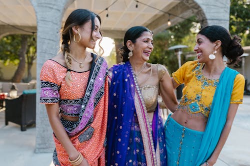 Women Dressed in Traditional Clothing Standing and Smiling Together