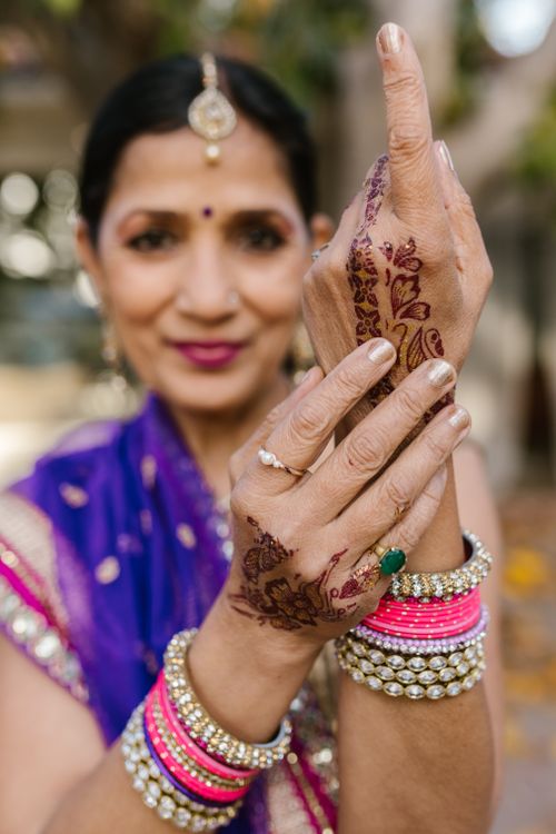 Free Close-up of a woman showcasing intricate henna designs with vibrant traditional attire. Stock Photo