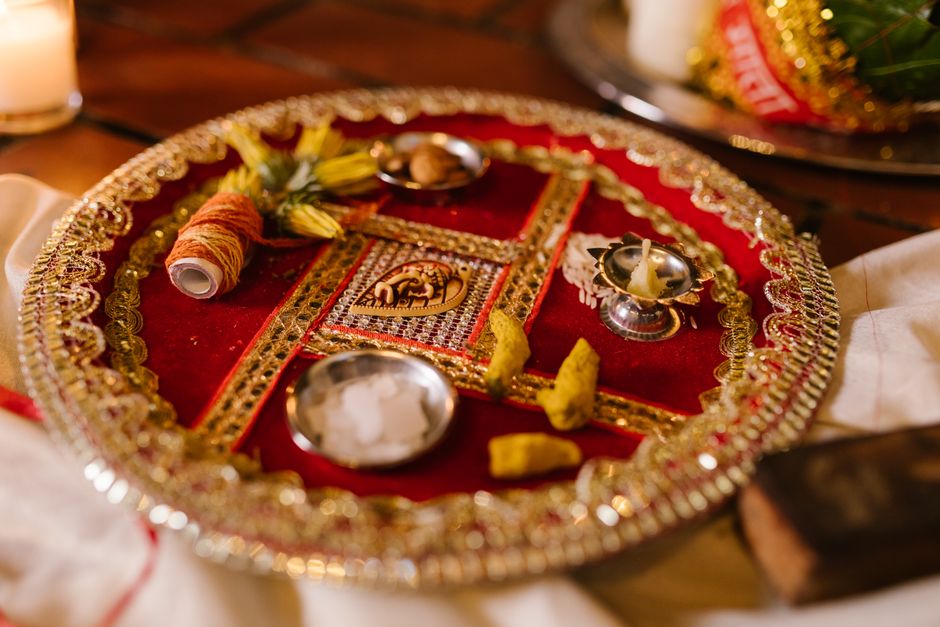 An intricately decorated Puja Thali used in traditional Indian religious rituals, featuring cultural elements.